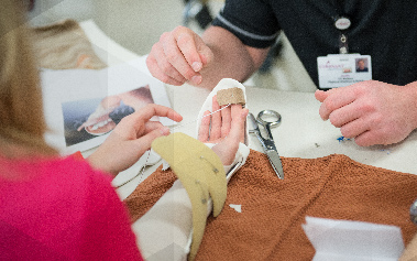Student re-bandaging an injury